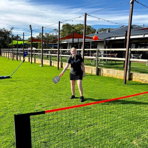 People playing outdoor lawn games at the club