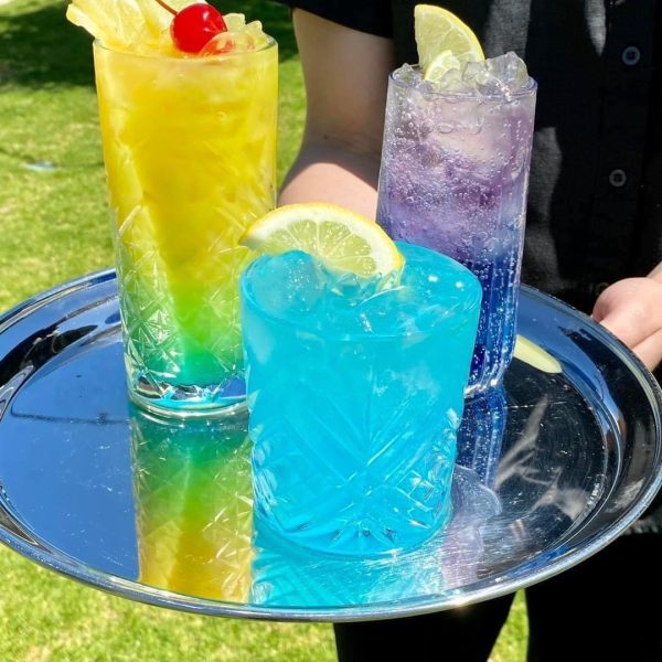 Colourful cocktails served on a tray outdoors