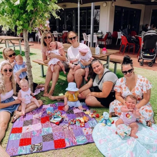 Families and babies enjoying a picnic at the club
