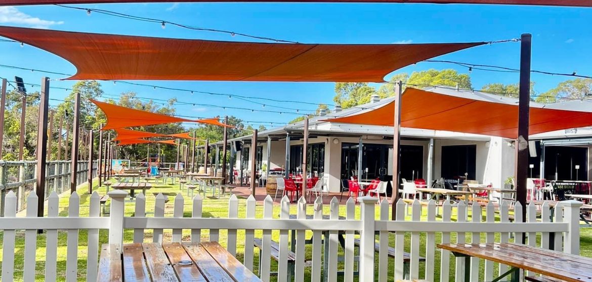 Outdoor club seating area with picnic tables